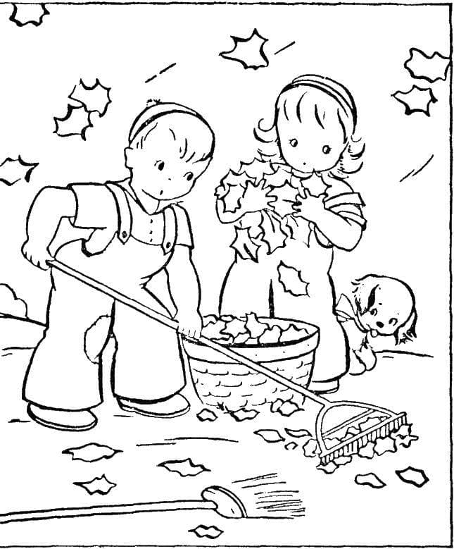 Мальчик с девочкой убирают листья
